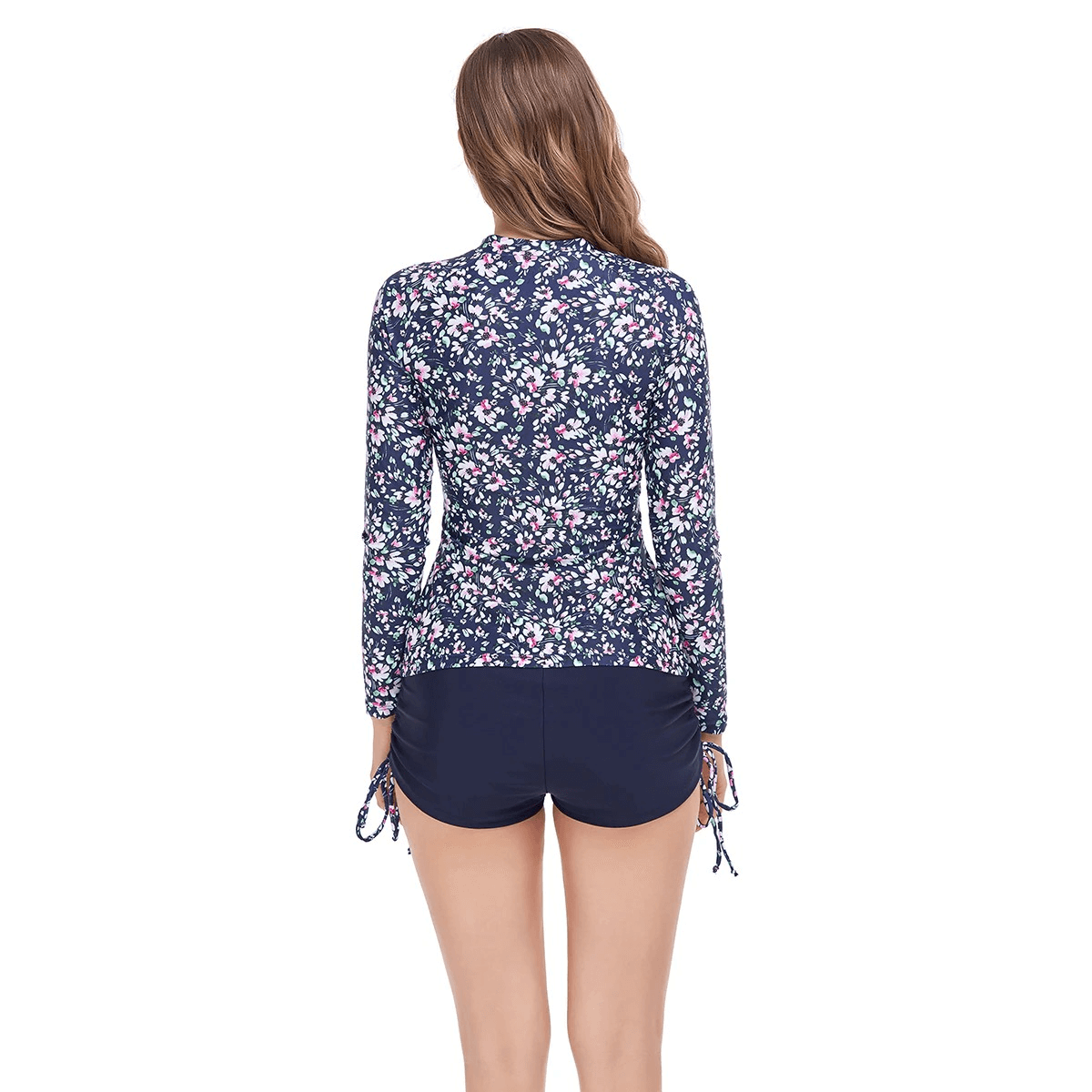 Back view of a fashionable women's two-piece swimsuit with long sleeves and zipper, featuring a floral print design for sun protection.